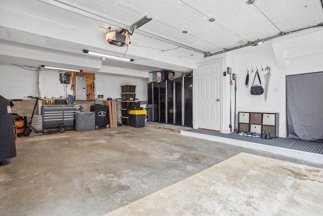 224 Grove St Unit 2, Waltham, MA 02453 - garage with electric panel and a garage door opener