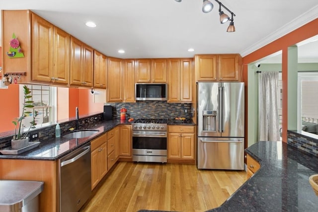 224 Grove St Unit 2, Waltham, MA 02453 - kitchen featuring stainless steel appliances, light wood-style flooring, tasteful backsplash, dark stone countertops, and a peninsula