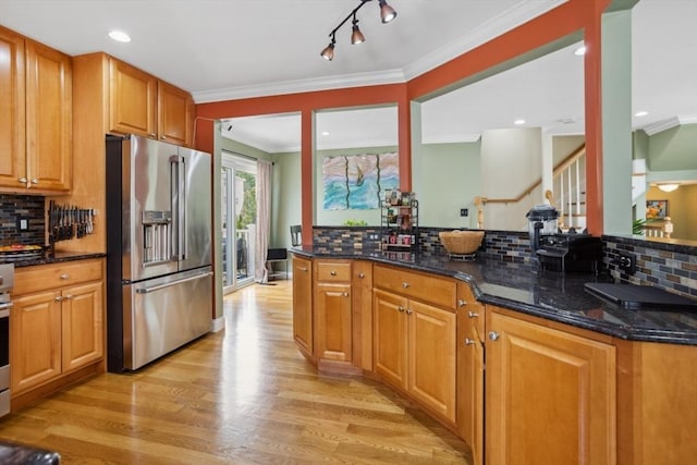 224 Grove St Unit 2, Waltham, MA 02453 - kitchen with appliances with stainless steel finishes, light wood-style flooring, decorative backsplash, ornamental molding, and dark stone countertops