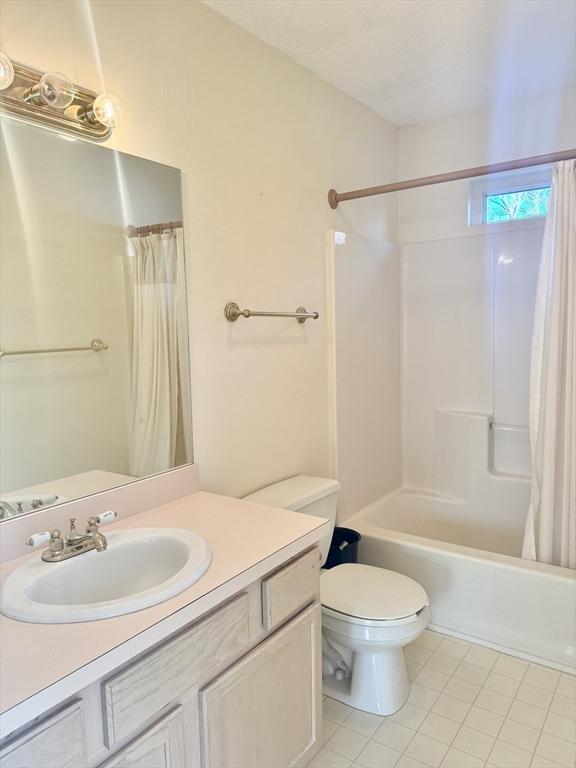 full bathroom with vanity, tile patterned flooring, toilet, and shower / bath combo