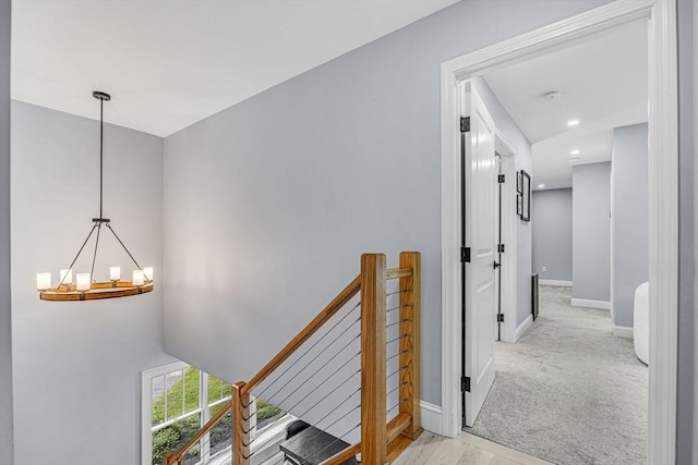 34 Cedar St, Hopkinton, MA 01748 - corridor with an upstairs landing, a chandelier, and light carpet