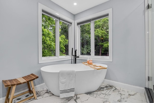 34 Cedar St, Hopkinton, MA 01748 - bathroom with marble look tile flooring, a soaking tub, a shower with shower door, and recessed lighting