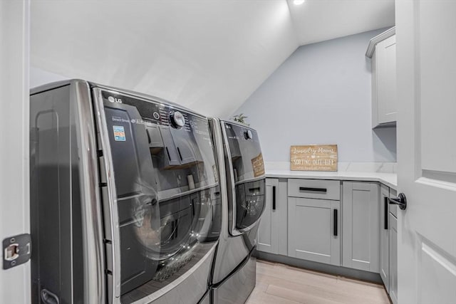 34 Cedar St, Hopkinton, MA 01748 - laundry area with separate washer and dryer, light wood-style floors, and cabinet space