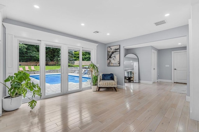 34 Cedar St, Hopkinton, MA 01748 - living area featuring light wood-style flooring, recessed lighting, and arched walkways