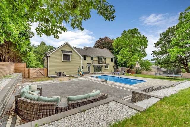 34 Cedar St, Hopkinton, MA 01748 - view of pool featuring a trampoline, a gate, a fenced backyard, an outdoor living space, and a patio area