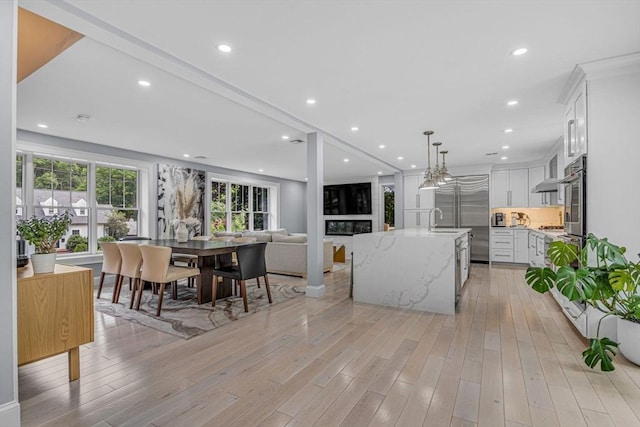 34 Cedar St, Hopkinton, MA 01748 - kitchen featuring light wood-style flooring, white cabinetry, open floor plan, stainless steel appliances, and recessed lighting