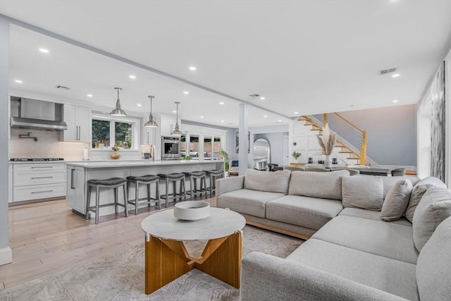 34 Cedar St, Hopkinton, MA 01748 - living room featuring stairway, light wood-style flooring, and recessed lighting