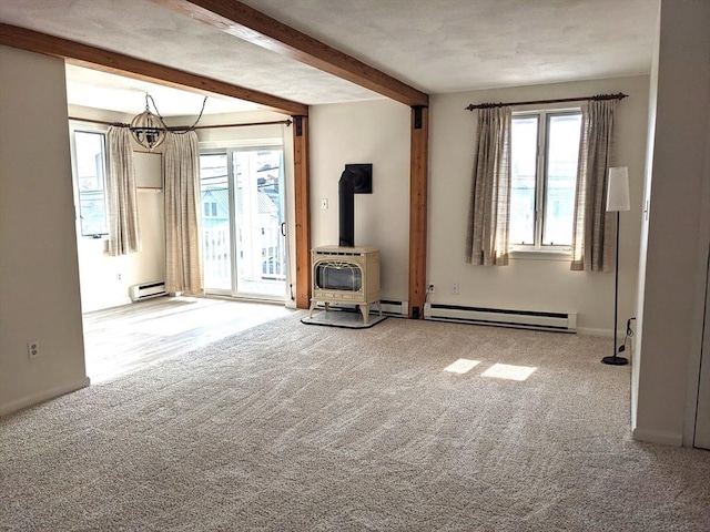 179 N End Blvd Unit A, Salisbury, MA 01952 - carpeted empty room with baseboard heating, a wood stove, beamed ceiling, a baseboard heating unit, and baseboards