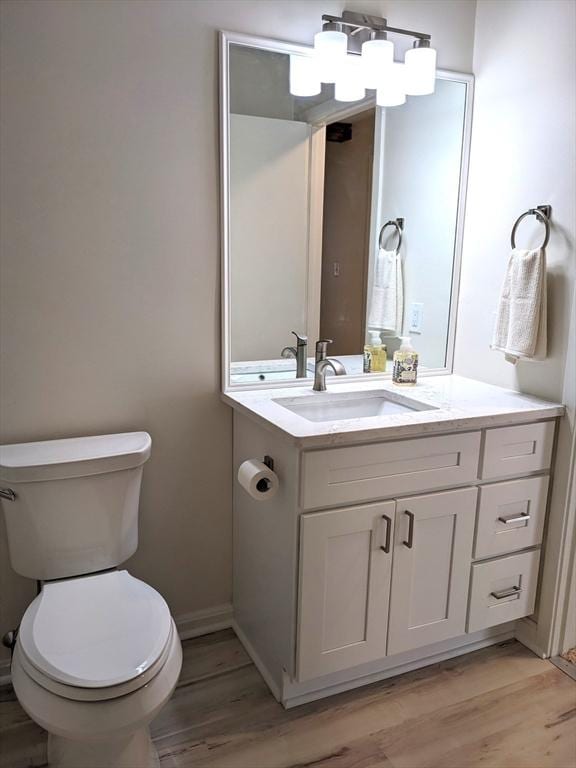 179 N End Blvd Unit A, Salisbury, MA 01952 - half bathroom featuring wood finished floors, vanity, toilet, and baseboards
