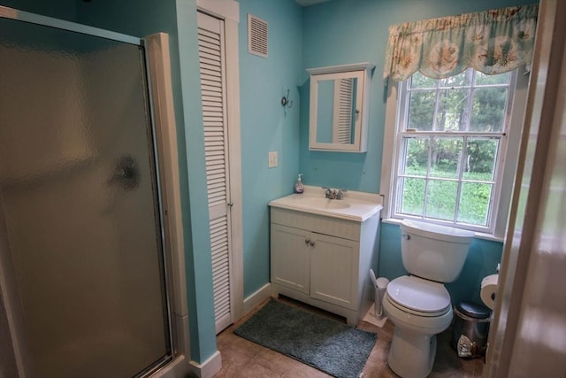 301 Main St, Dennis, MA 02639 - bathroom with a closet, vanity, a shower stall, toilet, and tile patterned flooring