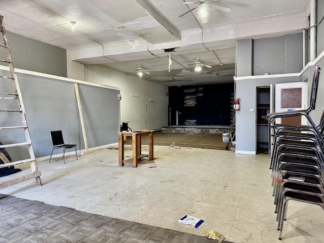 basement featuring tile patterned floors and ceiling fan