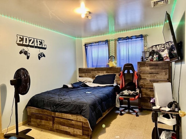 bedroom featuring visible vents, baseboards, and light floors