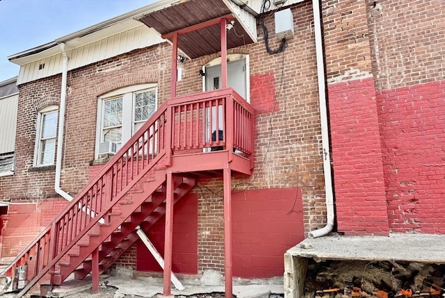 entrance to property featuring brick siding