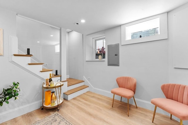 stairs with wood-type flooring and electric panel