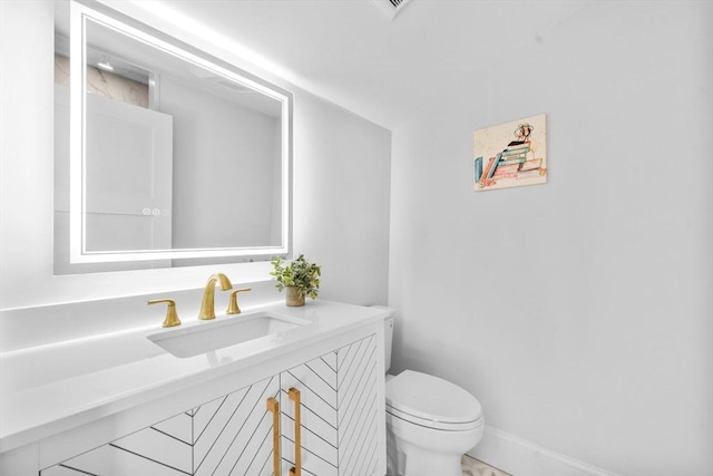 bathroom featuring toilet and vanity