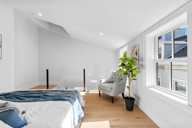 bedroom with lofted ceiling and light hardwood / wood-style flooring