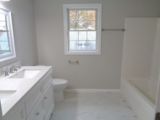 bathroom featuring plenty of natural light, toilet, and vanity