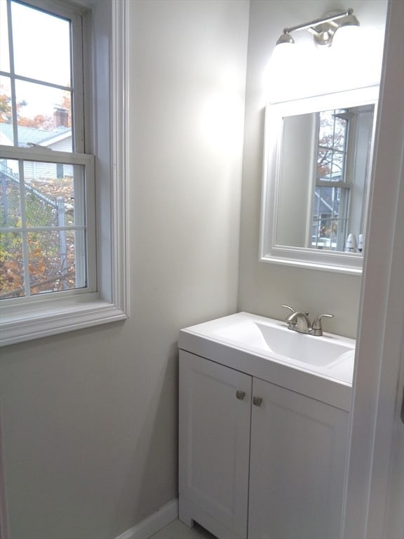 bathroom with plenty of natural light and vanity