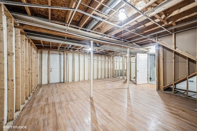 basement featuring wood-type flooring