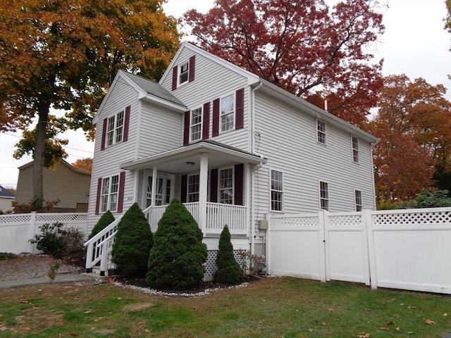 view of home's exterior featuring a porch and a yard