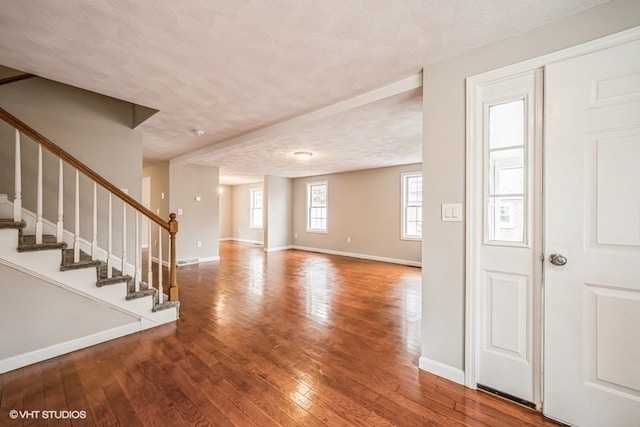 interior space with wood-type flooring and a textured ceiling