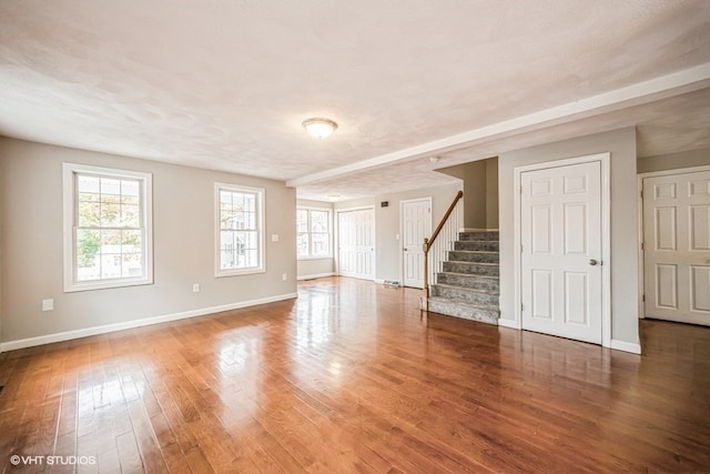 unfurnished room with a textured ceiling and dark hardwood / wood-style floors