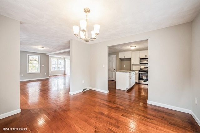 interior space featuring a chandelier, a textured ceiling, and dark hardwood / wood-style flooring