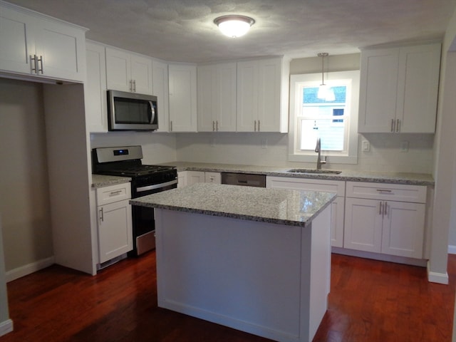 kitchen with dark hardwood / wood-style flooring, sink, white cabinets, and appliances with stainless steel finishes