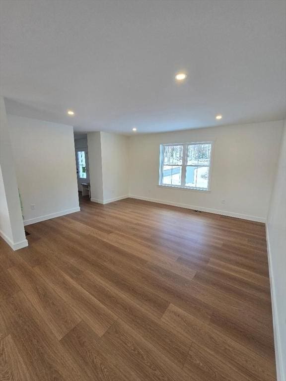 unfurnished room with dark hardwood / wood-style flooring