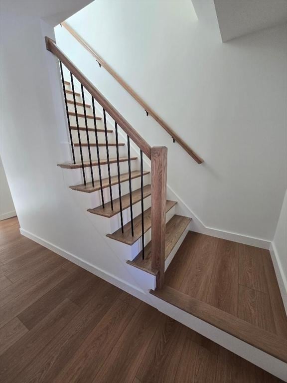 stairway with hardwood / wood-style floors