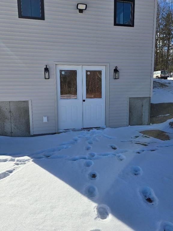 view of snow covered property entrance