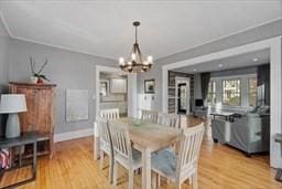 dining area with an inviting chandelier and light hardwood / wood-style floors