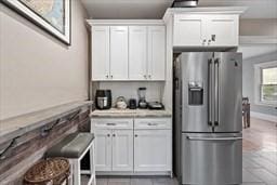 kitchen with high quality fridge and white cabinets