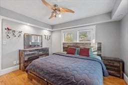 bedroom with light hardwood / wood-style flooring and ceiling fan