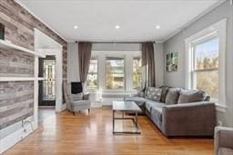 living room featuring ornamental molding and light hardwood / wood-style floors