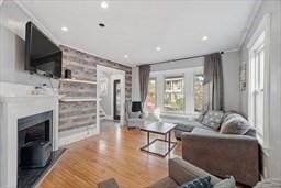 living room featuring hardwood / wood-style floors and ornamental molding