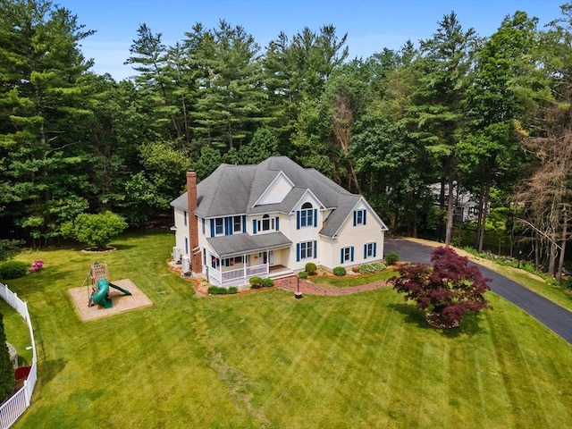 453 Forest St, North Andover, MA 01845 - view of front of property featuring a playground, a porch, a chimney, and asphalt driveway