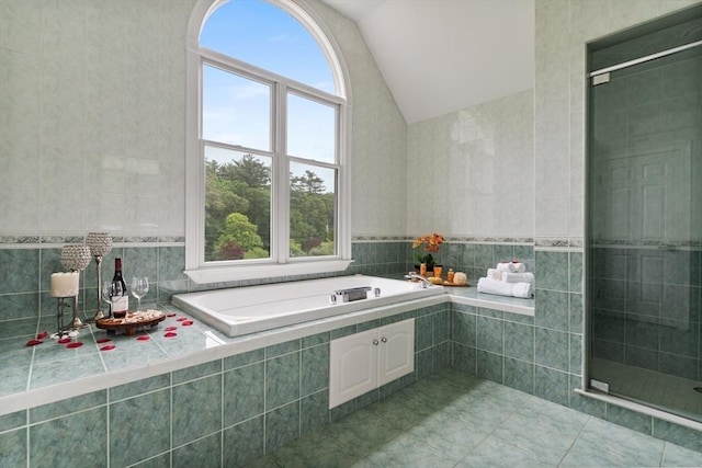453 Forest St, North Andover, MA 01845 - full bath featuring vaulted ceiling, plenty of natural light, a bath, a shower stall, and tile walls