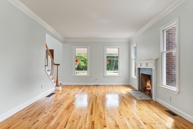 453 Forest St, North Andover, MA 01845 - unfurnished living room with wood finished floors, stairs, a premium fireplace, and crown molding