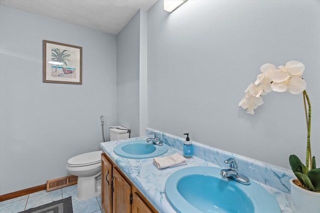 46 Lisa Ln, Methuen, MA 01844 - bathroom featuring tile patterned floors, double vanity, and a textured ceiling
