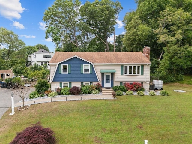 46 Lisa Ln, Methuen, MA 01844 - bi-level home featuring a chimney and a front lawn