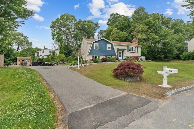 46 Lisa Ln, Methuen, MA 01844 - raised ranch featuring a gambrel roof, a front lawn, a chimney, and driveway