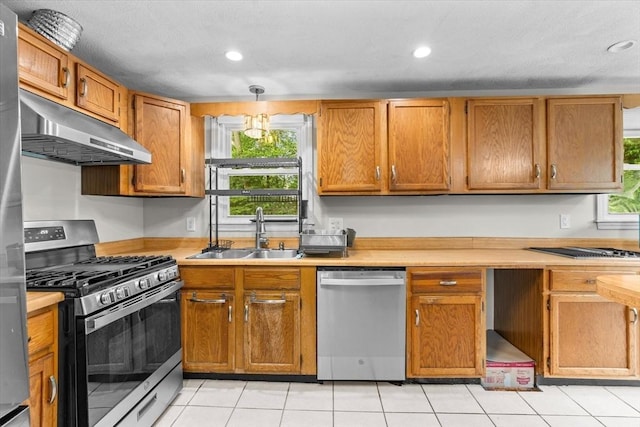 46 Lisa Ln, Methuen, MA 01844 - kitchen featuring stainless steel appliances, under cabinet range hood, light countertops, recessed lighting, and brown cabinets