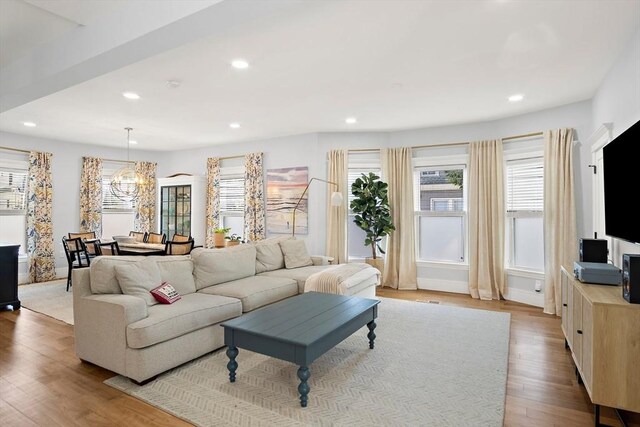 38 Thatcher St, Medford, MA 02155 - living area featuring healthy amount of natural light, recessed lighting, wood finished floors, and a chandelier