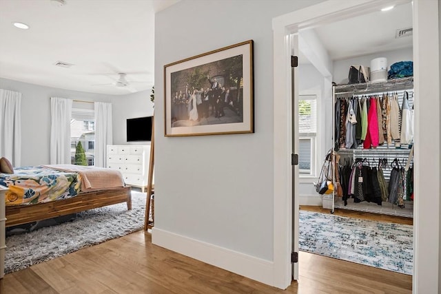 38 Thatcher St, Medford, MA 02155 - bedroom with wood finished floors, baseboards, recessed lighting, and a closet
