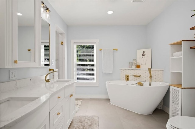 38 Thatcher St, Medford, MA 02155 - full bath with a soaking tub, double vanity, baseboards, and tile patterned floors