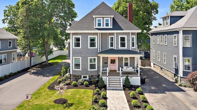 38 Thatcher St, Medford, MA 02155 - view of front of home featuring a porch, a chimney, fence, and roof with shingles