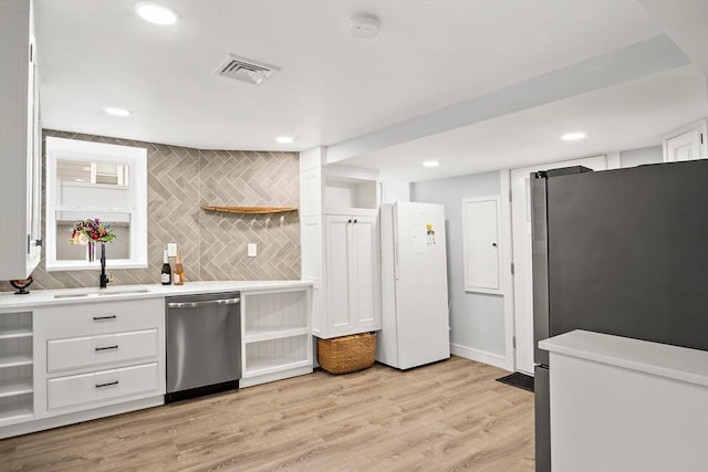 38 Thatcher St, Medford, MA 02155 - kitchen with stainless steel appliances, open shelves, a sink, white cabinets, and light countertops