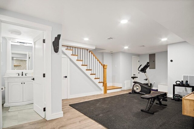 38 Thatcher St, Medford, MA 02155 - exercise room with baseboards, recessed lighting, a sink, and light wood-style flooring