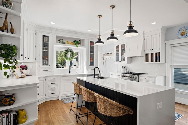 38 Thatcher St, Medford, MA 02155 - kitchen featuring open shelves, a sink, a kitchen island with sink, stainless steel stove, and recessed lighting